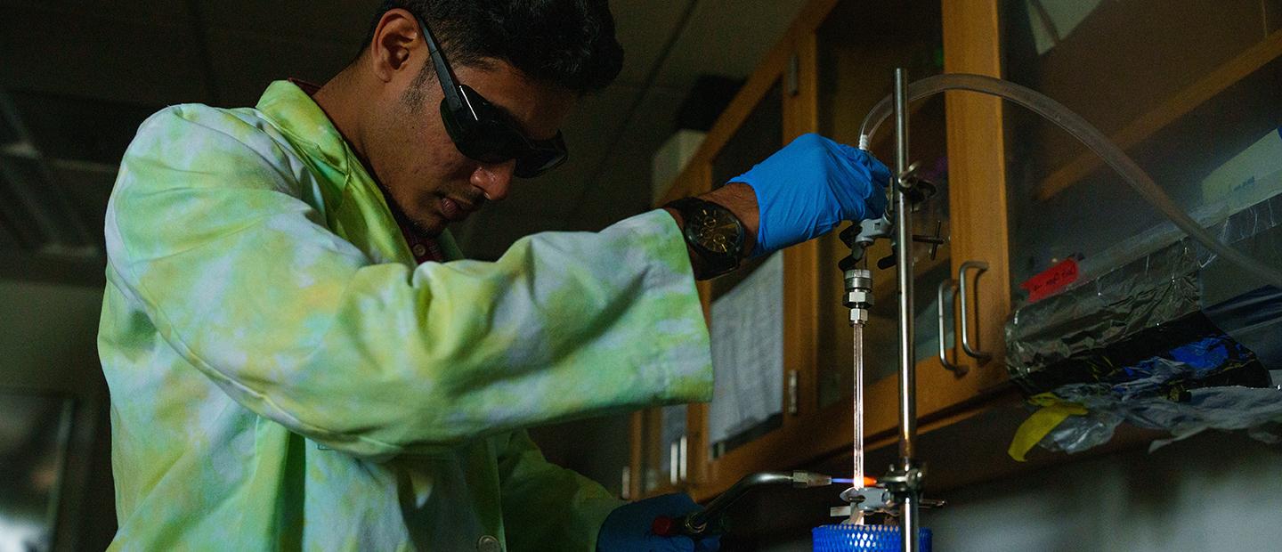 A young man working in a science lab